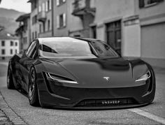 a black and white photo of a sports car