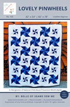 a blue and white quilt with the words lovely pinwheels written in black on it