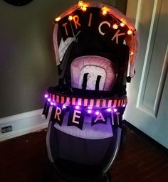 a baby's stroller with lights on it and the words treat spelled in black