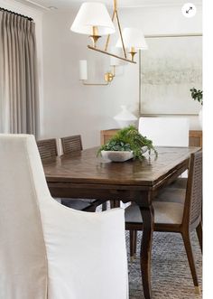 a dining room table with chairs and a bowl on it