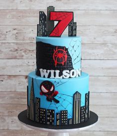 a spiderman themed birthday cake with the number seven on it's tiers