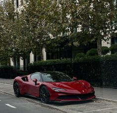 a red sports car is parked on the street