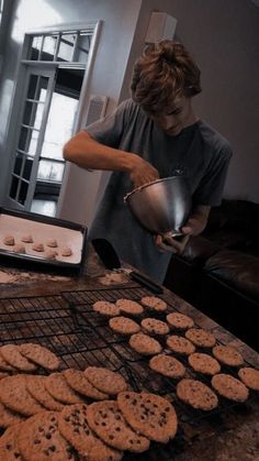 a woman cooking cookies on top of a grill