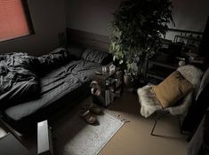 a bed room with a neatly made bed next to a window and a plant in the corner