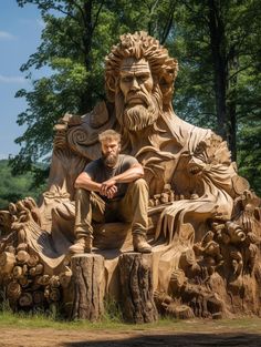 a man sitting on top of a wooden statue