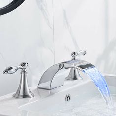 a faucet with water running out of it's side spout in a bathroom