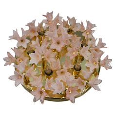 pink flowers are placed on a gold plate