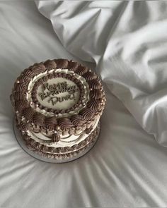 a decorated cake sitting on top of a white bed