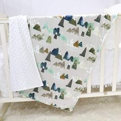 a baby crib with a blanket on top of it