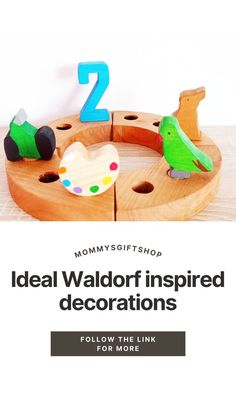 two wooden toys sitting on top of a table next to the words ideal walloft inspired decorations