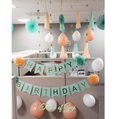 an office cubicle decorated with balloons and streamers for a happy birthday card of gig