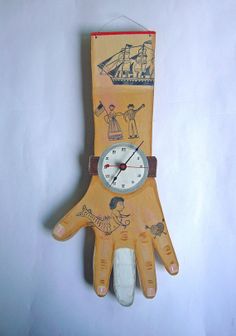 a clock made out of an oven mitt with children's drawings on it