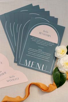 the wedding stationery is laid out with flowers