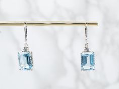 Artistic and yet elegant enough to pair with the most formal gown, these earrings are one of a kind, handmade in our New Hampshire studios. Bright blue topaz gemstones are set in polished prongs, allowing plenty of light through the gorgeous stones! Metal: 14K White GoldGem: 2 Blue Topaz totaling 18.57 CaratsGem Measurements: 14.2 x 10.1 mm, Emerald CutAccents: 2 DiamondsEarrings Length: 33 mmEarrings Width: 10 mmMarks: “14K” Stamped on the Findings White Gold Drop Earrings, Blue Topaz Pendant, Diamond Cocktail Rings, Formal Gown, Diamond Drops, Diamond Drop Earrings, Gold Drop Earrings, Topaz Gemstone, New Hampshire