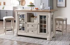 a kitchen island with two stools in front of it