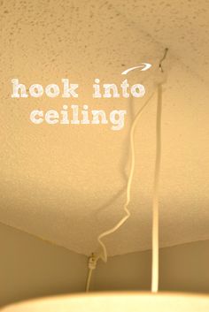 a ceiling light with the words hook into ceiling above it, and an electrical cord