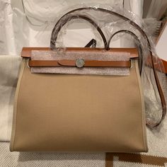 Brand New 2022 Hermes Herbag 31 In Trench/Fauve. Come With Original Receipt. Full Set, No Box. Open To Reasonable Offers. High-end Beige Satchel For Errands, Beige Bags With Leather Handles For Everyday Luxury, Everyday Luxury Beige Bags With Leather Handles, Beige Epsom Leather Bag With Detachable Strap, Brown Epsom Leather Bag With Handles, Brown Epsom Leather Bag, Epsom Leather Bag With Detachable Strap For Shopping, Beige Epsom Leather Travel Bag, High-end Beige Epsom Leather Bag