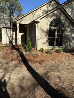 the shadow of a person standing in front of a house