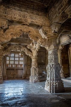 the interior of an old building with carved pillars