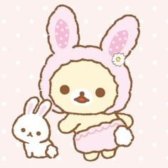 a cute little bunny holding onto a stuffed animal rabbit with polka dots in the background