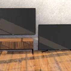 three flat screen televisions sitting on top of a wooden floor