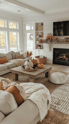 a living room filled with furniture and a fire place in the middle of the room