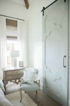 a bedroom with a bed, chair and sliding glass door