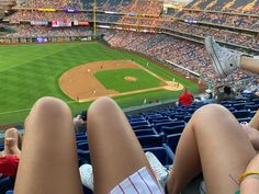 two people sitting in the stands at a baseball game