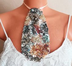 a necktie made out of sequins on a mannequin