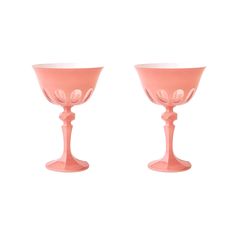 two pink goblets sitting next to each other