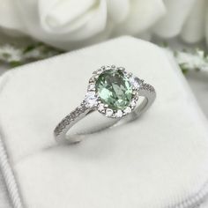 This beautiful ring is made from genuine 925 sterling silver with rhodium plating. Ring details- -The Main stone is an oval cut 8mm by 6mm Natural Green Amethyst Stone -Side stones are round 3mm and 1mm Round clear simulated diamonds -Ring is casted in solid 925 sterling silver with rhodium plating (rose gold and yellow gold plated also available, please check the drop down menu for more options) -The Total face height of the ring measures 10mms and the band width measures 1.5mms -Each ring is h Amethyst Wedding Ring, Wedding Ring Round, Amethyst Wedding Rings, Halo Art, Amethyst Wedding, Wedding Rings Round, Simulated Diamond Rings, Diamonds Ring, Deco Ring