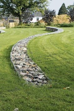 a stone path in the middle of a grassy field