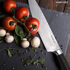 tomatoes, mushrooms and spinach on a cutting board next to a chef's knife