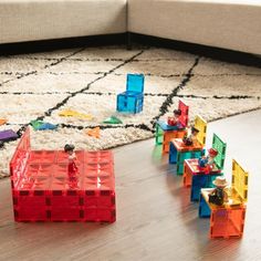 toy blocks are arranged on the floor in front of a couch