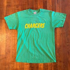 Dope jersey shirt from the '90s. Spellout on front and number on back. Has general wear and some cracking on the number otherwise in good condition. Fits S/M (18.5x26).  Brand: FOTL Size: S Color: Green, Yellow Condition: Good College Throwback T-shirt With Team Logo, Throwback Cotton Tops With Team Name, Green Crew Neck Retro Top, Retro College T-shirt For Football Season, Green T-shirt With Letter Print For Fans, Green Letter Print T-shirt For Fan Gear, Throwback Crew Neck T-shirt, Retro Green T-shirt For Fans, 90s Text Print Tops For College