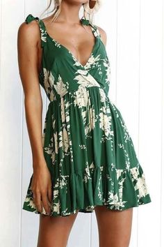 Ignite your Bohemian spirit with our Ebullient Deep V Mini Dress. This enchanting dress captures the essence of Bohemia with its vibrant design and alluring deep V neckline. Green Knee-length Floral Dress For Vacation, Green Mini Floral Dress For Beach, Printed Green Knee-length Mini Dress, Green Printed Mini Dress For Summer, Green Printed Summer Mini Dress, Green Printed Summer Dress, Summer Green Printed Mini Dress, Green Floral Print Summer Dress, Summer Printed Green Mini Dress