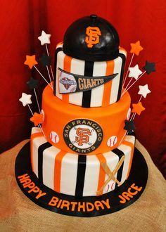 a three tiered birthday cake decorated with an orange and black striped uniform, baseball cap, and stars