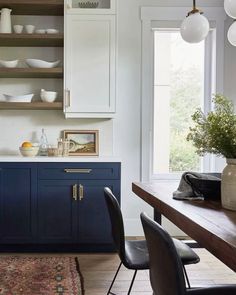 a dining room table with chairs and plates on top of it in front of a window