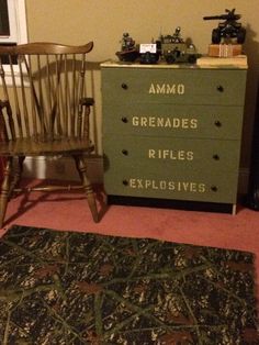 a green dresser sitting next to a wooden chair in a living room on top of a rug