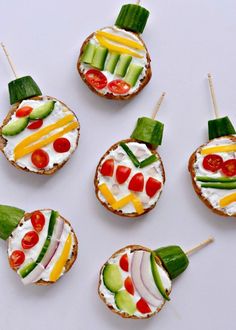 small appetizers are arranged in the shape of sandwiches with vegetables and cucumbers on them