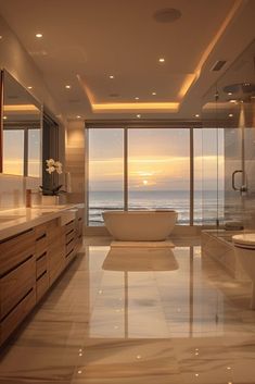 a large bathroom with an ocean view outside the window