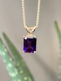 This is a simple, stunning deep purple amethyst! The natural amethyst sparkles with a rich inner fire. Amethyst is the birthstone for the month of February. A simple setting of 14K solid gold holds the amethyst without detracting from its beauty!  Details: Metal: 14K Yellow Gold Gem: Natural Amethyst  Gem Size: 6.10x8.3mm Pendant Size: 6.10x13.65 (with bail) Condition: New  *All Taxes Included for Canadian Customers.  Please understand that the photos are ENLARGED to show detail for your benefit Formal Purple Birthstone Gemstones, Purple Amethyst Necklace With Prong Setting, Purple Necklace With Prong Setting For Anniversary, Purple Prong Set Necklace For Anniversary, Purple Necklace With Prong Setting As A Gift, Purple Necklace With Prong Setting, Gift, Purple Amethyst Gemstones With Prong Setting, Purple Emerald Cut Birthstone Jewelry, Classic Purple Necklace For Anniversary