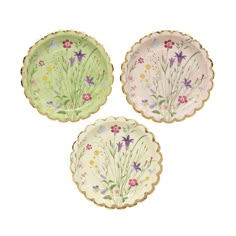 three plates with flowers painted on them, one is green and the other is pink