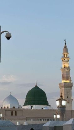 a tall white building with a green dome