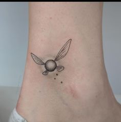 a small bee tattoo on the ankle