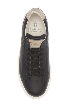 A lightweight rubber sole offers cushiony comfort as well as color contrast to the grained calfskin-leather upper of this refined Italian-crafted sneaker. Lace-up style Leather upper and lining/rubber sole Made in Italy Designer Shoes Black Calf Leather Sneakers With Textured Sole, Black Textured Sole Calf Leather Sneakers, Classic Black Calf Leather Sneakers, Luxury Calf Leather Sneakers With Stitched Sole, Classic Custom Sneakers With Textured Sole For Sports, Color Contrast, Brunello Cucinelli, Up Styles, Low Top