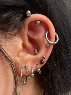 an ear with several piercings attached to it