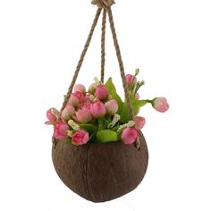 a hanging planter filled with pink flowers and greenery