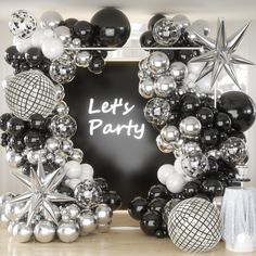 a black and white party decoration with balloons