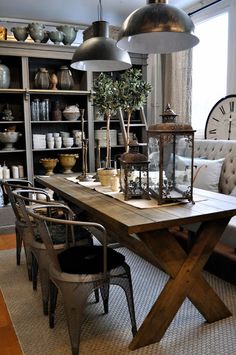 a dining room table with chairs and lights